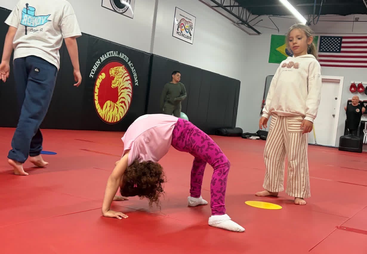 Young gymnast holding a bridge