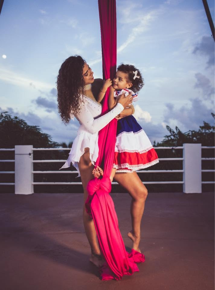 Mother and daughter sharing an aerial silks moment at sunset